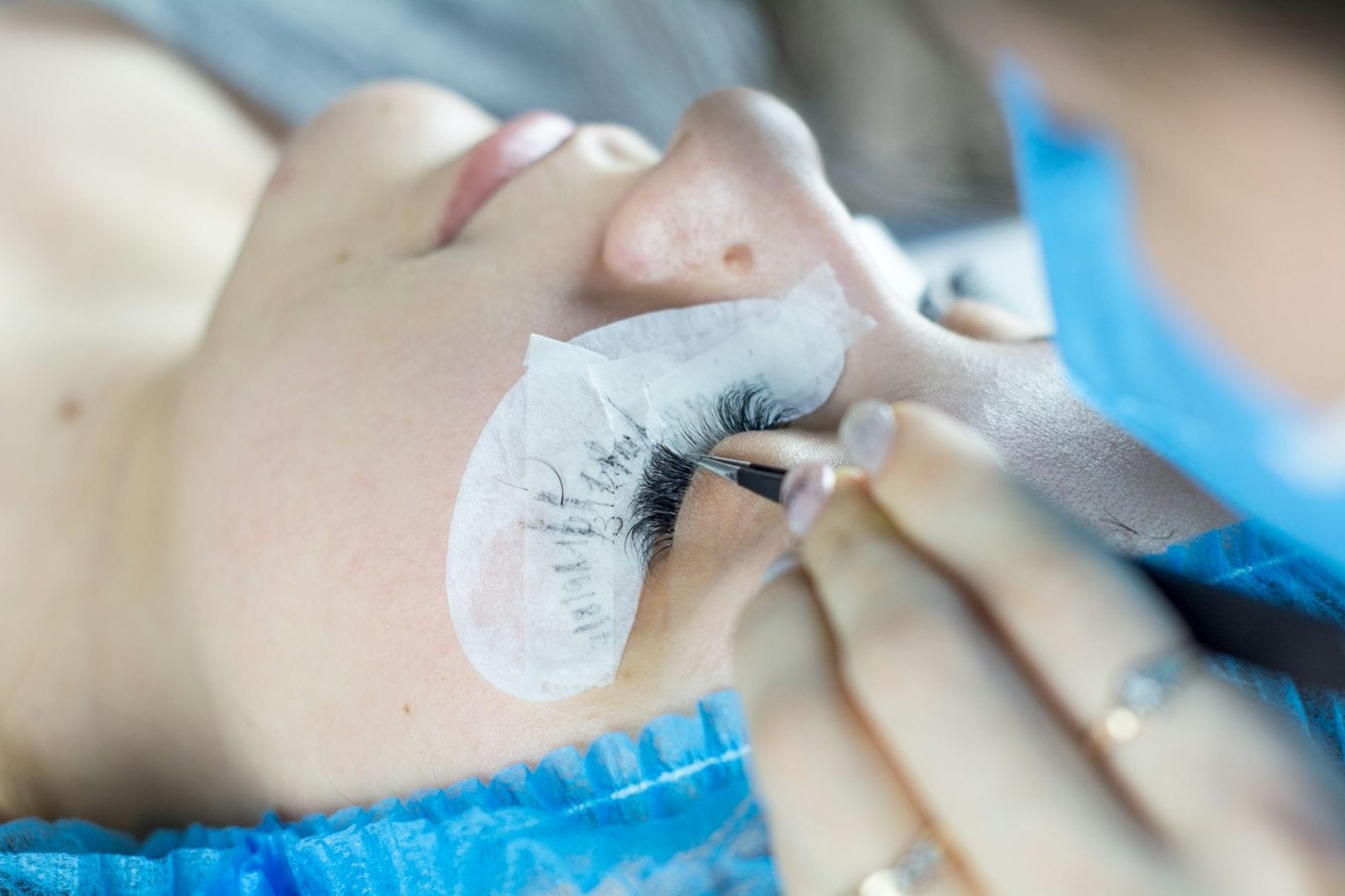 Client with under-eye pads during a lash treatment