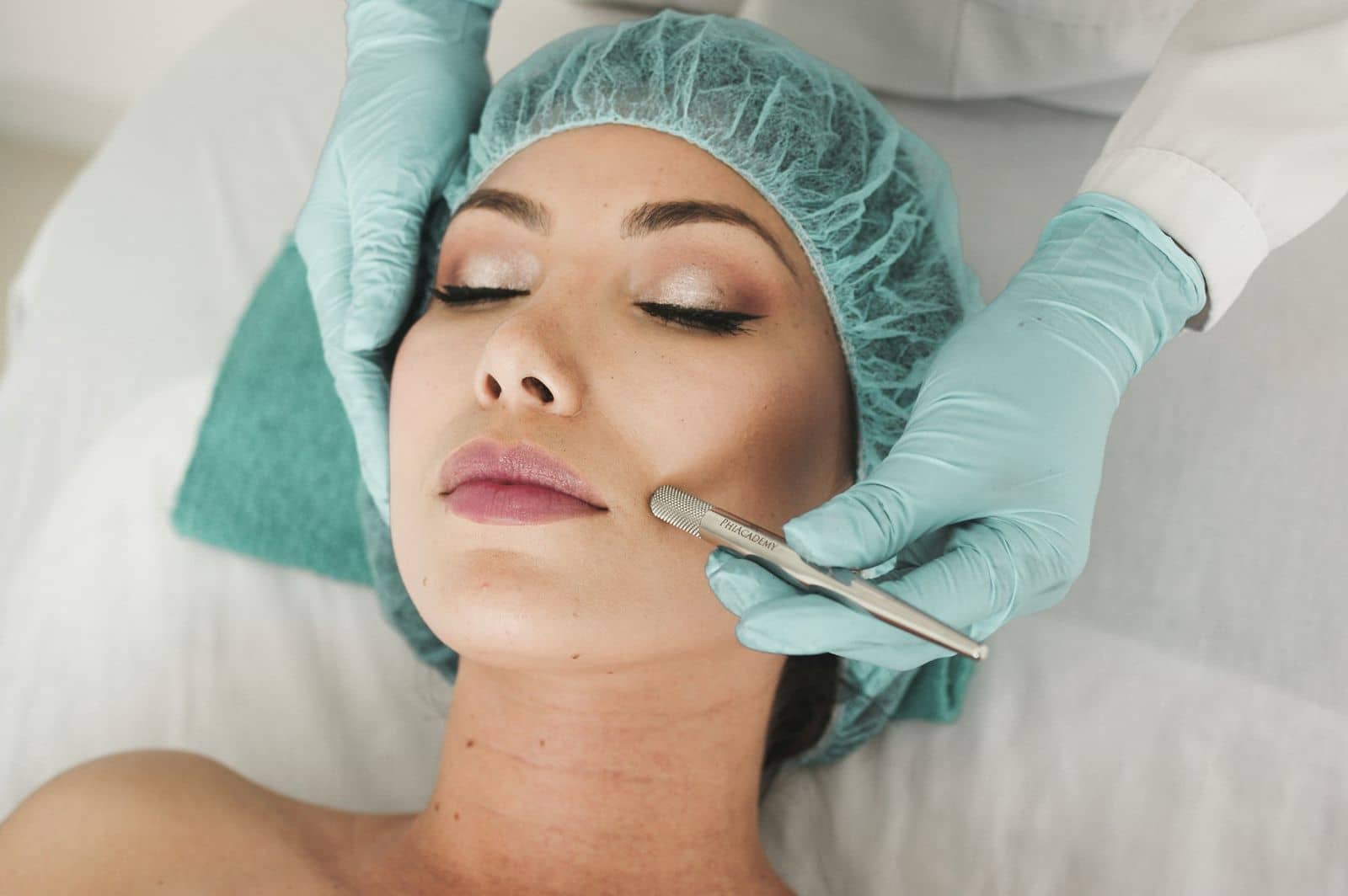 Therapist in gloves performing a facial treatment